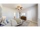 Inviting bedroom with a ceiling fan, plush carpet and a dresser under a TV at 16047 E Geddes Ln # 128, Aurora, CO 80016