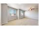 Bonus room with natural light shining through the large windows at 16047 E Geddes Ln # 128, Aurora, CO 80016