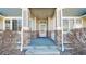 Charming front porch with stone accents, offering a welcoming entrance to the home at 16047 E Geddes Ln # 128, Aurora, CO 80016