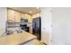 Kitchen with wooden cabinets, black appliances, and a stainless steel faucet at 16047 E Geddes Ln # 128, Aurora, CO 80016