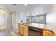Well-equipped kitchen with wood cabinets, open to the dining area, creating a seamless flow at 16047 E Geddes Ln # 128, Aurora, CO 80016