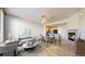 Open-concept living room features a fireplace, dining area and adjacent kitchen space, creating a warm, inviting atmosphere at 16047 E Geddes Ln # 128, Aurora, CO 80016