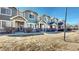 Charming townhomes with well-kept lawns and inviting entrances, showcasing curb appeal and community charm at 16047 E Geddes Ln # 128, Aurora, CO 80016