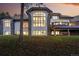 Rear exterior view of the house showcasing a large window, a deck area, and natural surroundings with mature trees at 2548 Keystone Dr, Evergreen, CO 80439