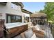 Inviting backyard deck featuring a hot tub, seating area, and outdoor dining space with mountain views at 2548 Keystone Dr, Evergreen, CO 80439