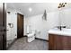 Modern bathroom with a glass-enclosed shower, wood vanity, and hexagonal tile floor, adding elegance and functionality at 2548 Keystone Dr, Evergreen, CO 80439