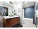 Contemporary bathroom featuring a wood vanity, modern fixtures, and stylish blue tile, blending luxury and comfort at 2548 Keystone Dr, Evergreen, CO 80439