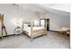 Rustic-chic bedroom with a four-poster bed, cozy chair, and unique pendant lighting creating a warm ambiance at 2548 Keystone Dr, Evergreen, CO 80439