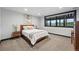 Modern bedroom with picture window and beautiful scenic views at 2548 Keystone Dr, Evergreen, CO 80439