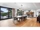 Spacious dining room with a modern chandelier, fireplace and access to an outdoor deck with beautiful views at 2548 Keystone Dr, Evergreen, CO 80439