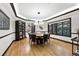 Bright dining room features wood floors, a decorative chandelier, and large windows at 2548 Keystone Dr, Evergreen, CO 80439