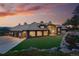 Stunning exterior view of the home with meticulously manicured lawn, stone accents, and a grand entrance with a three car garage at 2548 Keystone Dr, Evergreen, CO 80439