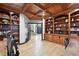 Elegant office space with custom wood ceiling, built-in bookcases, and an open doorway to the home at 2548 Keystone Dr, Evergreen, CO 80439