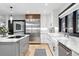 Modern kitchen featuring stainless steel appliances, custom cabinets, and an island with a cooktop at 2548 Keystone Dr, Evergreen, CO 80439