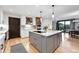 Bright eat-in kitchen featuring an island, modern appliances, and light wood floors at 2548 Keystone Dr, Evergreen, CO 80439