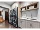 Updated laundry room features cabinetry, a countertop, a sink, and a stacked washer/dryer at 2548 Keystone Dr, Evergreen, CO 80439