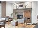 Cozy living area with a stone fireplace, hearth, and inviting seating perfect for relaxation and entertaining guests at 2548 Keystone Dr, Evergreen, CO 80439