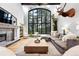 Bright living room boasts soaring ceilings, expansive windows, a stone fireplace, and stylish furnishings at 2548 Keystone Dr, Evergreen, CO 80439