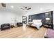 Stylish main bedroom featuring a wood accent wall, hardwood floors, and abundant natural light at 2548 Keystone Dr, Evergreen, CO 80439