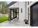 Covered porch features stone columns, a concrete floor, recessed lighting, and a view of the front yard at 2548 Keystone Dr, Evergreen, CO 80439