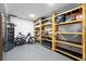 Basement storage with custom shelving and a wine refrigerator at 2548 Keystone Dr, Evergreen, CO 80439