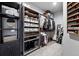 Organized walk-in closet with custom shelving, hanging rods, and ample storage space at 2548 Keystone Dr, Evergreen, CO 80439