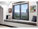Comfortable window seat with views of distant mountains, perfect for relaxation, reading, or enjoying nature at 2548 Keystone Dr, Evergreen, CO 80439