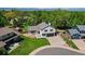 Aerial view of a well-maintained home with a lush lawn, mature trees, and a spacious driveway at 7633 S Gilpin Ct, Centennial, CO 80122