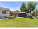 Expansive backyard with lush lawn, stock tank pool, greenhouse, and shed, perfect for outdoor relaxation at 7633 S Gilpin Ct, Centennial, CO 80122