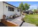 Inviting backyard patio with outdoor seating, lush lawn, and a charming stock tank pool and greenhouse at 7633 S Gilpin Ct, Centennial, CO 80122