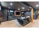 Finished basement featuring a large TV, custom built-ins, and stylish furnishings at 7633 S Gilpin Ct, Centennial, CO 80122