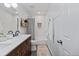 Clean bathroom with double sinks, white subway tile, and a shower-tub combination at 7633 S Gilpin Ct, Centennial, CO 80122