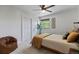 Bright bedroom with paneled walls, ceiling fan, and natural light from the window at 7633 S Gilpin Ct, Centennial, CO 80122