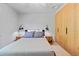 Cozy bedroom with a queen-sized bed, minimalist decor, and sleek modern storage at 7633 S Gilpin Ct, Centennial, CO 80122