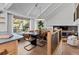 Open-concept dining room featuring bright natural light, stylish furniture, and hardwood floors at 7633 S Gilpin Ct, Centennial, CO 80122