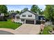 Beautiful two-story home showcasing a well-kept lawn, mature trees, and a spacious driveway leading to a garage at 7633 S Gilpin Ct, Centennial, CO 80122