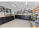 Well-organized garage workshop with ample storage, workbenches and natural light at 7633 S Gilpin Ct, Centennial, CO 80122