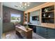 Inviting home office with custom built-ins, desk, and a view from the window at 7633 S Gilpin Ct, Centennial, CO 80122