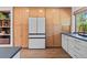 Kitchen showcases full wall of wood cabinets, stainless appliances, and hardwood floors at 7633 S Gilpin Ct, Centennial, CO 80122