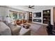 Stylish living room with a fireplace, built-in shelves, and bright natural light with comfortable seating at 7633 S Gilpin Ct, Centennial, CO 80122