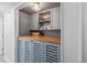 Charming pantry with custom cabinets, wood countertop, and stylish lighting at 7633 S Gilpin Ct, Centennial, CO 80122