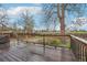 Large wood deck with black metal railings overlooks yard and mature trees at 4623 S Kalispell Way, Aurora, CO 80015