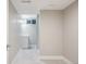 Basement area with gray paint, white trim and floors, leading to a small bathroom at 4623 S Kalispell Way, Aurora, CO 80015