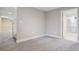 This area of the basement has gray walls, neutral carpet, and a bathroom in the back at 4623 S Kalispell Way, Aurora, CO 80015
