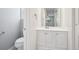 This bathroom includes a toilet, sink with vanity and a mirror on the wall at 4623 S Kalispell Way, Aurora, CO 80015