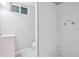 This basement bathroom has white walls, a sink, a toilet, and a plastic shower at 4623 S Kalispell Way, Aurora, CO 80015