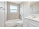This bathroom has tiled walls, and a bathtub with a shower and a decorative vertical tiled accent at 4623 S Kalispell Way, Aurora, CO 80015