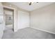 This bedroom features neutral walls, carpet, and a closet with sliding white doors at 4623 S Kalispell Way, Aurora, CO 80015