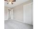 This bedroom features neutral walls, carpet, ceiling fan, and a closet with white doors at 4623 S Kalispell Way, Aurora, CO 80015