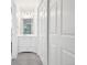 This hallway has a vanity with a mirror, lighting, and a closet with white doors at 4623 S Kalispell Way, Aurora, CO 80015